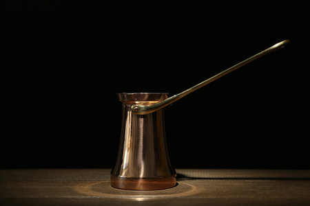 Beautiful copper turkish coffee pot on wooden tableの写真素材
