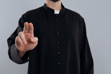 Priest making blessing gesture on gray background, closeupの写真素材