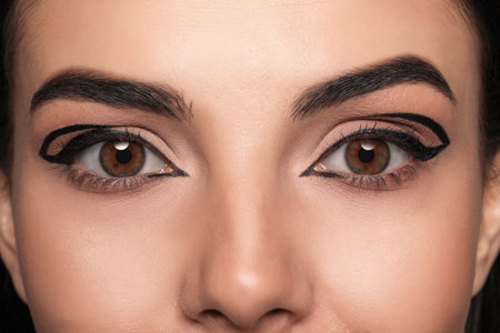Beautiful woman with black eyeliner, closeup viewの写真素材