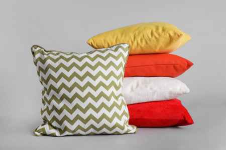 Different stylish soft pillows on gray backgroundの写真素材