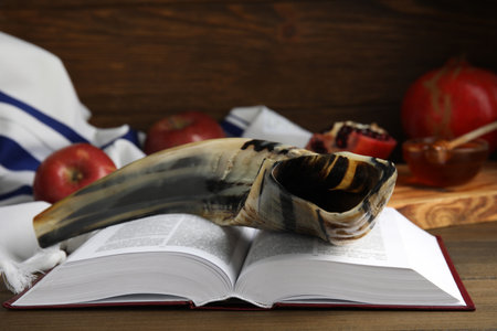 Shofar and open Torah on wooden table, closeup. Rosh Hashanah celebrationの写真素材