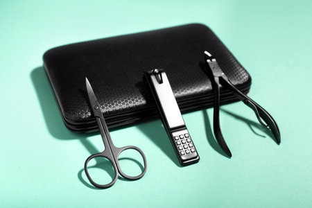Set of manicure tools near case on turquoise background, closeupの写真素材