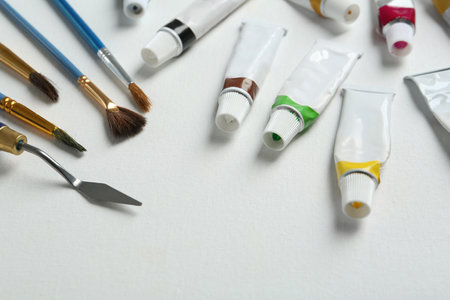 Brushes, spatula and paints on blank canvas, closeupの写真素材