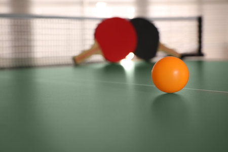 Yellow ball on  table tennis, space for textの写真素材