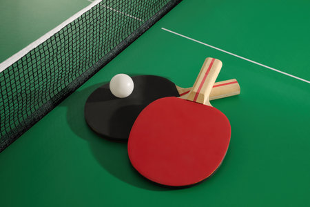 Rackets and ball near net on table tennisの写真素材