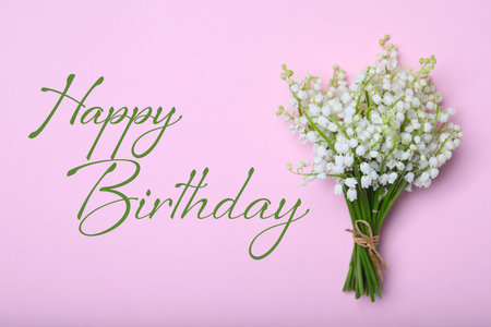 Happy Birthday! Beautiful lily of the valley flowers on pink background, top viewの写真素材