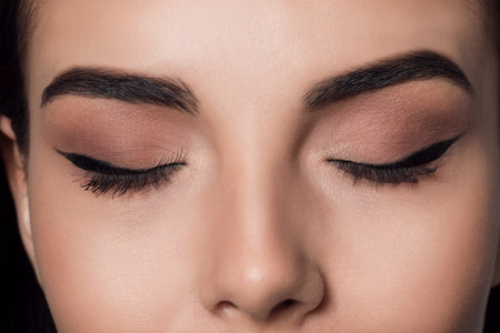 Beautiful woman with black eyeliner, closeup viewの写真素材