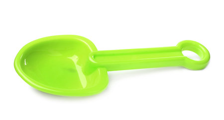 Green plastic toy shovel isolated on whiteの写真素材