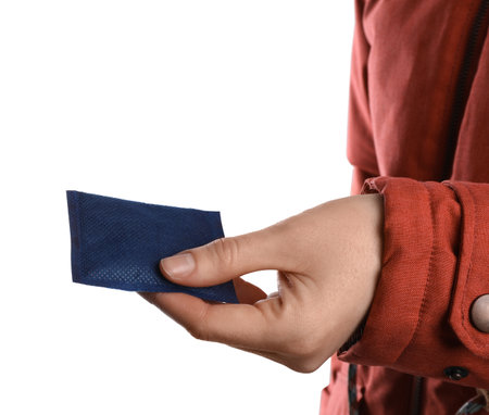 Woman holding hand warmer on white background, closeupの写真素材