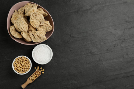 Flat lay composition with dried soy meat on black table. Space for textの写真素材