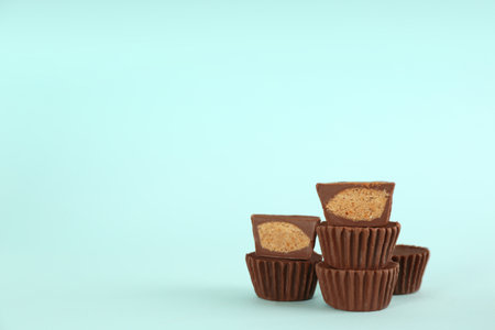 Sweet peanut butter cups on turquoise background. Space for textの写真素材
