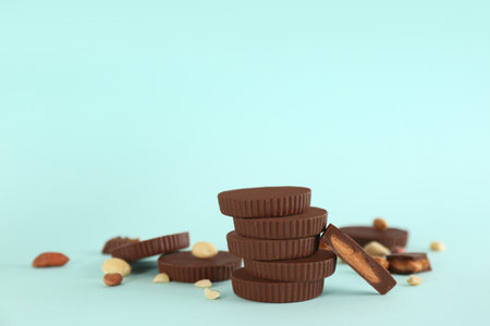 Sweet peanut butter cups on turquoise background. Space for textの写真素材