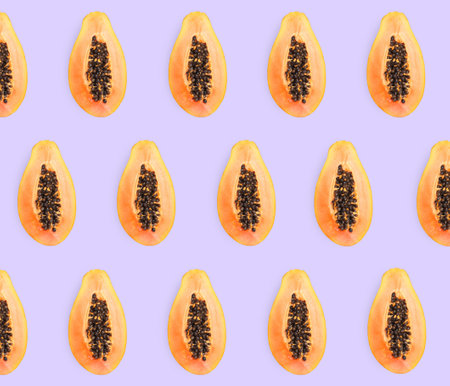Delicious cut papaya fruits on lilac background, flat layの写真素材