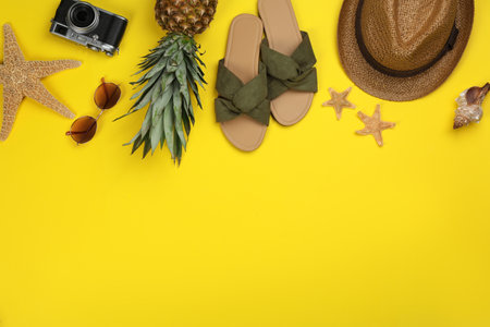 Flat lay composition with beach objects on yellow background, space for textの写真素材