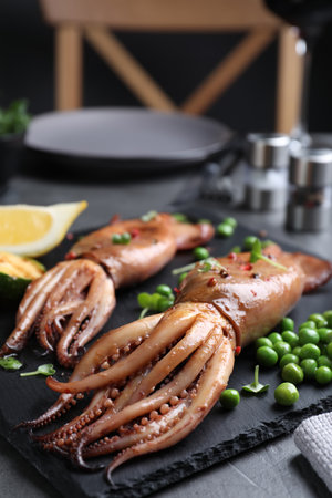Tasty grilled squids served on black table, closeupの写真素材