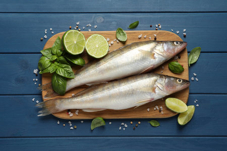Fresh raw pike perches and ingredients on blue wooden table, flat lay. river fishの写真素材