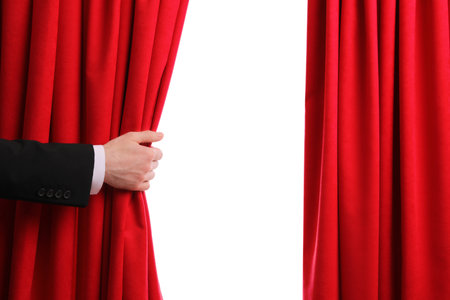 Man opening red front curtains on white background, closeupの写真素材