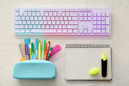 Flat lay composition with modern RGB keyboard on white wooden tableの写真素材