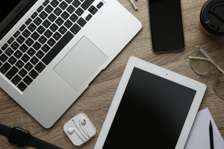 MYKOLAIV, UKRAINE - JULY 20, 2020: Flat lay composition with iPhone 11 and different Apple gadgets on wooden tableのeditorial素材