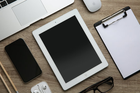 MYKOLAIV, UKRAINE - JULY 20, 2020: Flat lay composition with iPhone 11 and different Apple gadgets on wooden tableのeditorial素材