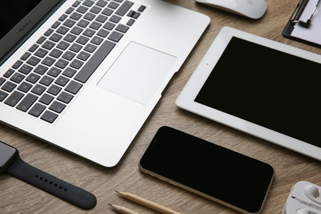 MYKOLAIV, UKRAINE - JULY 20, 2020: Composition with iPhone 11 and different Apple gadgets on wooden tableのeditorial素材