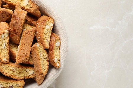 Traditional Italian almond biscuits (Cantucci) on light marble table, top view. Space for textの写真素材