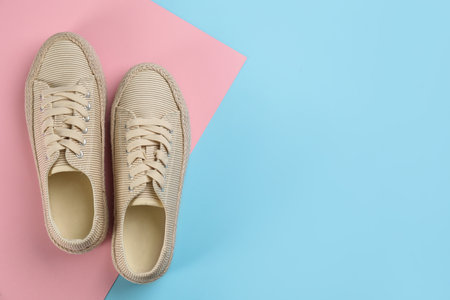 Pair of stylish sneakers on color background, flat lay. Space for textの写真素材