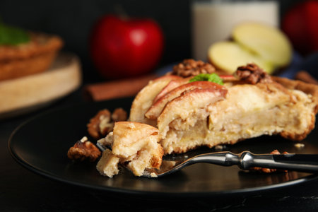 Fork with delicious apple pie on black table, closeupの写真素材