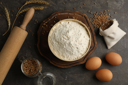 Flat lay composition with wheat flour on dark gray tableの写真素材