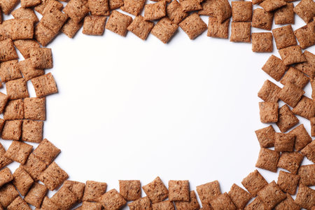 Frame made with delicious chocolate corn pads on white background, top view. Space for textの写真素材