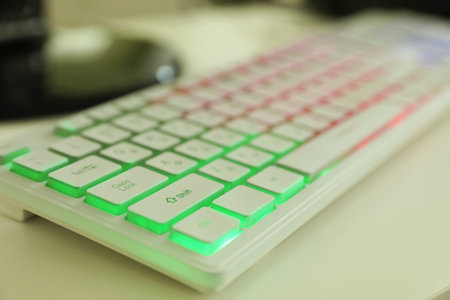 Modern RGB keyboard on white table indoors, closeupの写真素材