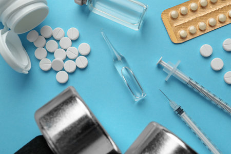 Different drugs and sports equipment on turquoise background, flat lay. doping controlの写真素材