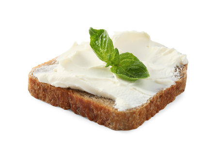 Bread with cream cheese and basil isolated on whiteの写真素材
