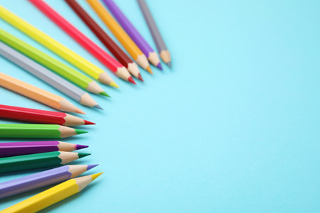 Colorful wooden pencils on light blue background, above view. Space for textの写真素材
