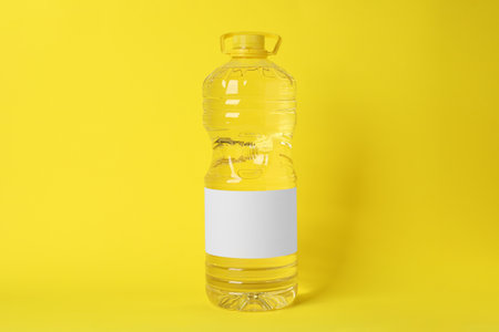 Bottle of cooking oil on yellow backgroundの写真素材