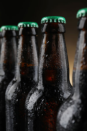 Many bottles of beer on dark background, closeupの写真素材