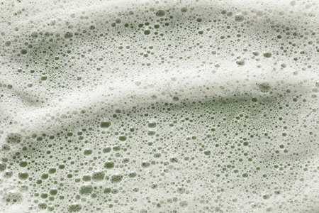 White washing foam on olive background, top viewの写真素材