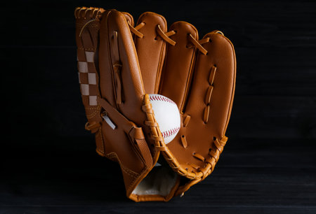 Catcher's mitt and baseball ball on black background. sports gameの写真素材
