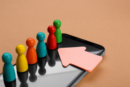 Recruitment process, job competition concept. Arrow pointing at red pawn among others on beige backgroundの写真素材