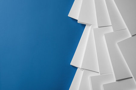 Many stacks of paper sheets on blue background, flat lay. Space for textの写真素材