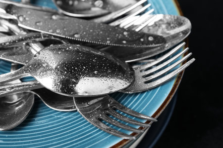 Different kitchenware after washing on black table, closeupの写真素材
