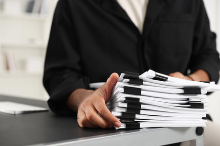 Man with documents at table in office, closeupの写真素材