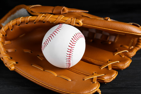 Catcher's mitt and baseball ball on black background, closeup. sports gameの写真素材