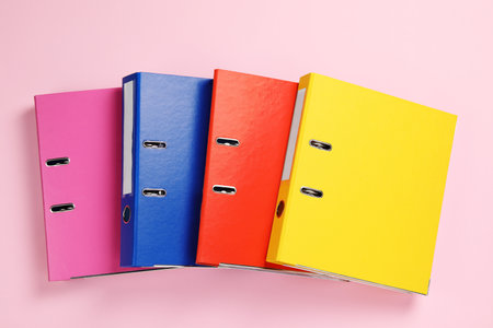 Office folders on pink background, flat layの写真素材