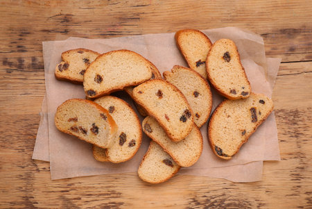 Sweet hard chuck crackers with raisins on wooden table, flat layの写真素材