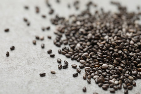 Pile of chia seeds on light gray table, closeup. Space for textの写真素材