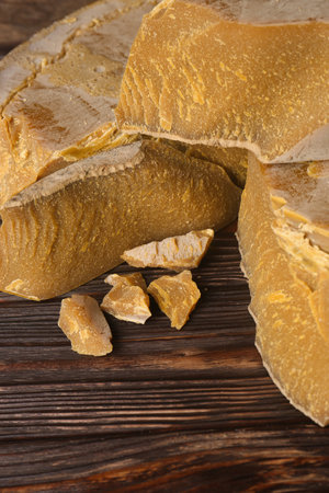 Natural organic beeswax blocks on wooden table, above view. Space for textの写真素材