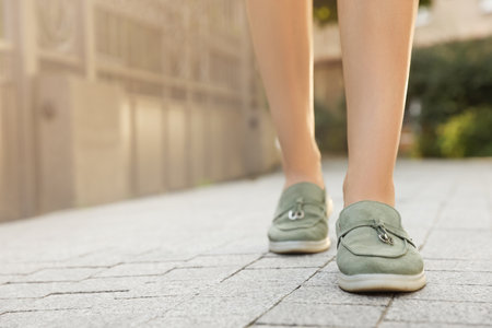 Woman in stylish loafers walking on city street, closeup. Space for textの写真素材