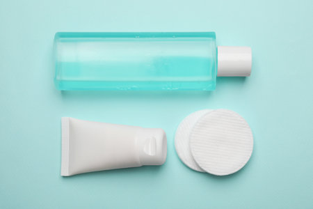 Flat lay composition with bottle of micellar cleansing water on turquoise backgroundの写真素材