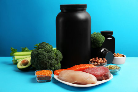 Set of products rich in amino acids and supplements on light blue backgroundの写真素材